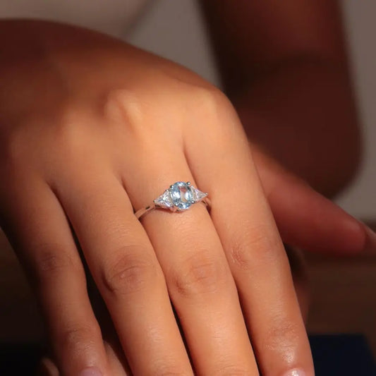 Oval Blue Topaz and Moissanite Ring in Rhodium-Plated Sterling Silver – 4x4mm, 0.6ct